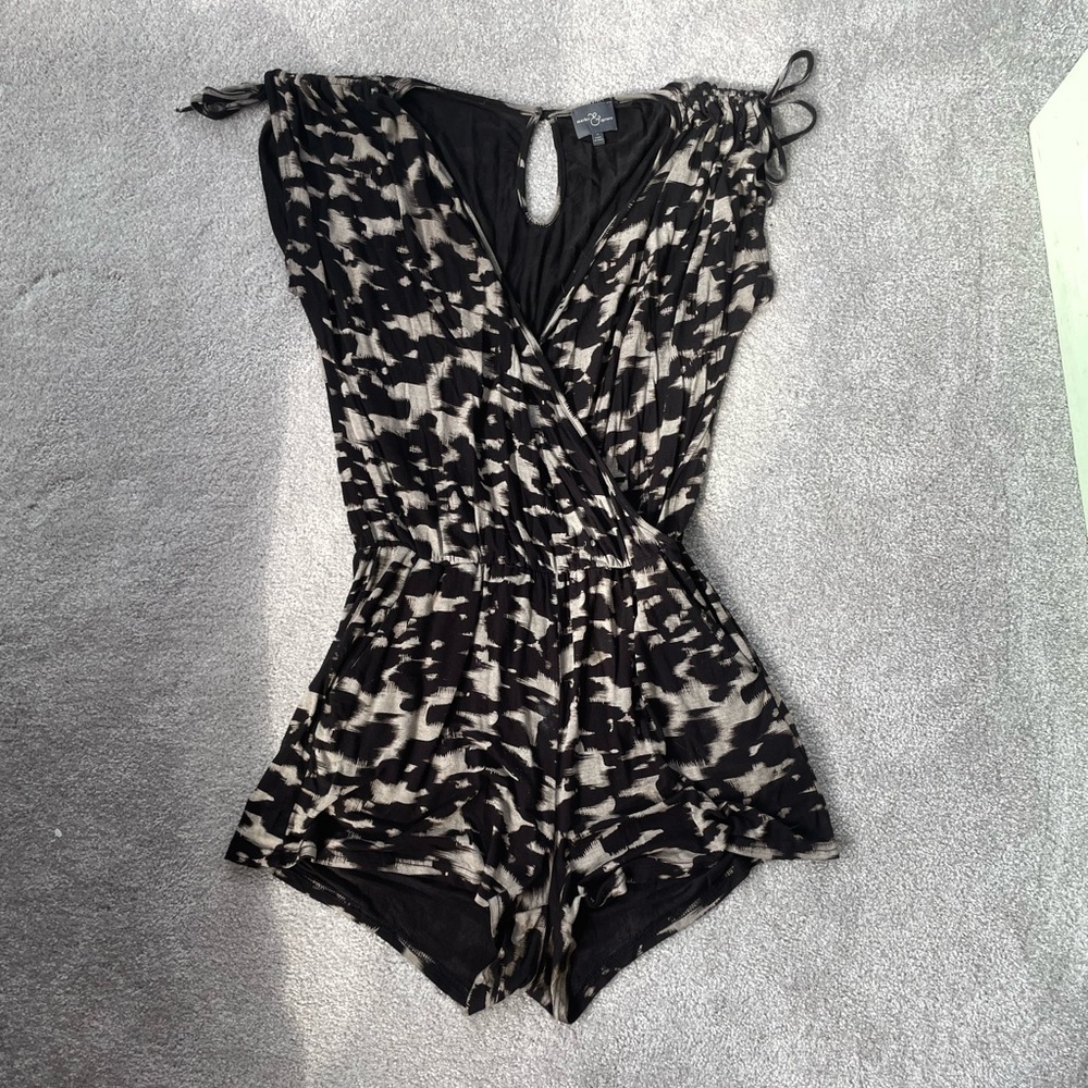 Black and white flowy romper with shoulder ties and pockets